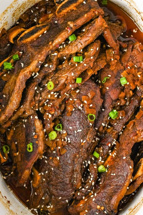 These Slow Cooker Korean Short Ribs come together quickly with little active prep time. The Korean-flavored marinade season these to perfection. Korean Beef Short Ribs Slow Cooker, Korean Bbq Ribs Slow Cooker, Beef Chuck Short Ribs Recipes Bone In, Beef Flanken Ribs Recipes Crockpot, Crockpot Korean Short Ribs, Korean Ribs Crockpot, Slow Cooker Short Ribs Recipe Crock Pots, Slow Cooker Korean Short Ribs, Chinese Short Ribs Recipe