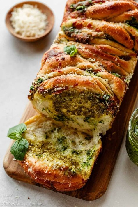 Buttery-soft and flaky, this pesto pull apart bread is brimming with fresh flavor. Stuff homemade herbed dough with mozzarella cheese and homemade pesto, then arrange it all in a loaf pan. When it's fresh out of the oven, add a dose of garlic butter and watch as the bread disappears piece by torn-apart piece. Recipe on sallysbakingaddiction.com Pesto Pull Apart Bread, Savory Bread, Pull Apart Bread, Homemade Pesto, Pull Apart, Loaf Pan, Loaf Bread, Garlic Butter, Mozzarella Cheese