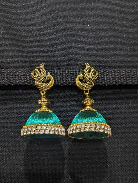 Antique gold plated Peacock stud with Silk thread jhumka. Earring length: 2.25 inches; Width: 1.25 inches. Handmade Silk Thread large size Jhumka. Earring adds color to your attire.Please allow some variation in color. Please avoid exposure to water.Please note: Returns are not accepted for Silk thread earrings. Silk Thread Jhumkas, Silk Thread Earrings Designs, Handmade Wallpaper, Silk Thread Bangles Design, Silk Thread Earrings, Thread Bangles Design, Silk Thread Jewelry, Silk Thread Bangles, Thread Bangles