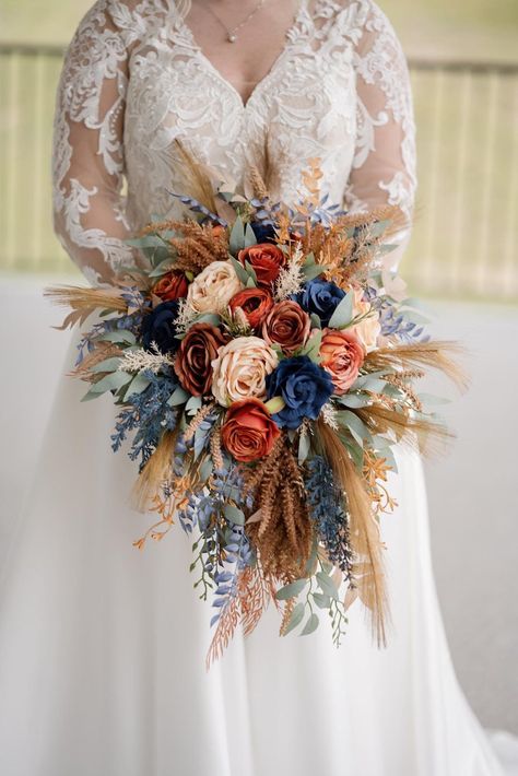 All the flowers and greenery is artificial and of high quality! September Bride Bouquet, Rusty Orange And Blue Wedding, Rust Navy Wedding, Boho Wedding Flower Arrangements, Rust And Navy Blue Wedding, Fall Wedding Flowers November, Fall Wildflower Bouquet, Fall Wildflower Wedding, Fall Wedding Ideas Colors