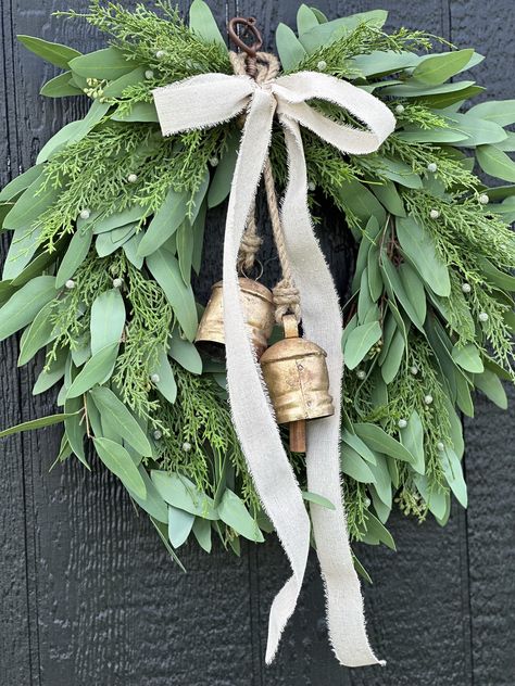 "Intentionally curated for a festive and joyous holiday season. Our 2023 holiday collection features transitional pieces designed for Christmas and can be displayed through winter.  🌿 Similar to our best selling olive and juniper wreath that is no longer available. 🌿 Our Willow and Juniper wreath adds warmth and natural elegance to doors, mantles and interior spaces this holiday season.  🌿 Meticulously handcrafted in our studio, made lush and full and designed to last for many seasons.  🌿 measures 18-19\" Wide X 18-19\"Tall and 4\" depth  🌿 measures 24\" wide X 24\" tall X 6\" depth   🌿 Bells are crafted from iron with a gold finish, tied with twine and add a beautiful finishing touch.  🌿 Bow and bells are included  ☀️❄️ give your wreath  protection from UV rays, water and snow with Velvet Ribbon Christmas Wreath, Juniper Wreath, Bell Wreath, Copper Christmas, Bow Wreath, Wreath Winter, Christmas Door Wreaths, Natural Christmas, Wedding Wreaths