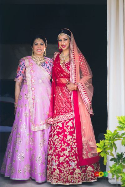 Mother if the Bride Outfit - Bride in a Gold and Red Lehenga with A Net Dupatta and the Mother in a Pink Lehenga with a Blue and Pink Blouse | WedMeGood #wedemegood #indianbride #indianwedding #bridal #lehenga #bridallehenga #pink #red #mauve #motherofthebrideoutfit Mom Lehenga, Lilac Lehenga, Lavender Lehenga, Pics Edit, Mother Daughter Wedding, Brides Mom, Mother Of Bride Outfits, Indian Bride Outfits, Bride Outfits