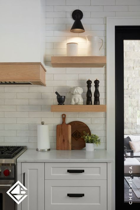 White oak floating shelves next to a range hood in a white modern farmhouse kitchen. White Oak Shelves, White Modern Farmhouse Kitchen, Teal Island, White Modern Farmhouse, Kitchen Cabinet Layout, Glass Cabinets, Custom Range Hood, Modern Farmhouse Kitchen, U Shaped Kitchen