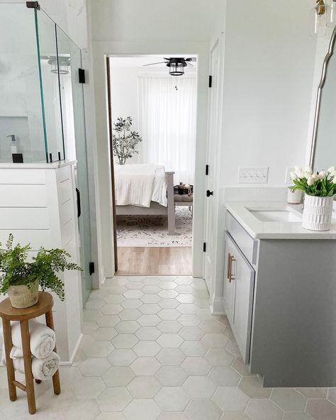 Hexagon tile is very popular, but what's unique about this design is the individual hues of each hexagon piece. Instead of one color palette that extends the length of the floor, there are very subtle creams, grays, and beige tones spread throughout. This is a great way to tie in a statement gray vanity with white shiplap and brown accent pieces. Hexagon Tiles In Bathroom, Makoto Hexagon Tile, Bathroom Hexagon Tile Floor White, Bathroom Flooring Ideas Hexagon, 8 Inch Hexagon Tile Floor, Bathroom Floor Tile With White Vanity, Tile Flooring In Bathroom, Bathroom Floor Tile And Shower Tile, Oblong Hexagon Tile Bathroom