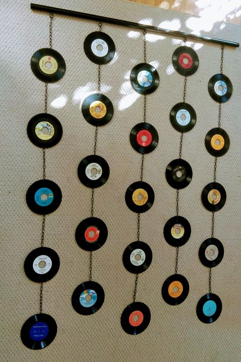 "A new series of mixed-media wall hangings/beaded curtains, made out of real 7\" records.  Hung with stainless steel jack chain on 1\" wooden dowel, for a total length of 6 feet and width of 5 feet. I can also adjust or add to the current length. Makes an excellent addition to bedroom, art studio, living rooms, any kind of music or creative spaces. To hang, you simply need to install some kind of ceiling hook and/or fishing line to adjust the height. Records are fragile, so make sure to take out Bedroom Art Studio, Record Diy, Vinyl Records Diy, Vinyl Record Decor, Records Diy, Record Decorations, Vinyl Record Wall Art, Vinyl Record Crafts, Cd Wall