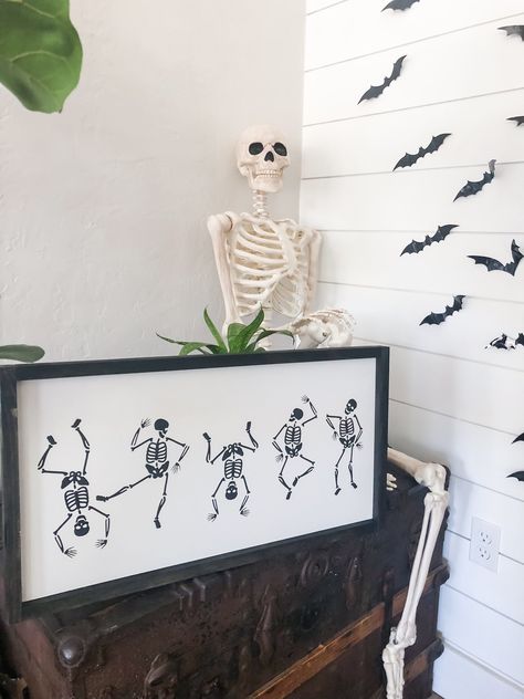 Dancing skeletons wood framed sign. Pictures has ebony stain for the border Acrylic paint. Not vinyl!! 12x24 plus border wood sign + spruce up your decor with this trendy handmade sign! + Please note - due to the nature of wood; stain color, knots and grain may vary. There may be imperfections in the finished product. This adds to the individual character of the sign, meaning each one will be unique in its own way! + Please make sure that your address is correct, all items will ship to your Etsy Spooky Fall Decor, Fall Cricut, Skeletons Halloween, Sunflower Home Decor, Fall Wood Signs, Sign Meaning, Wood Signs For Home, Dancing Skeletons, Handmade Sign