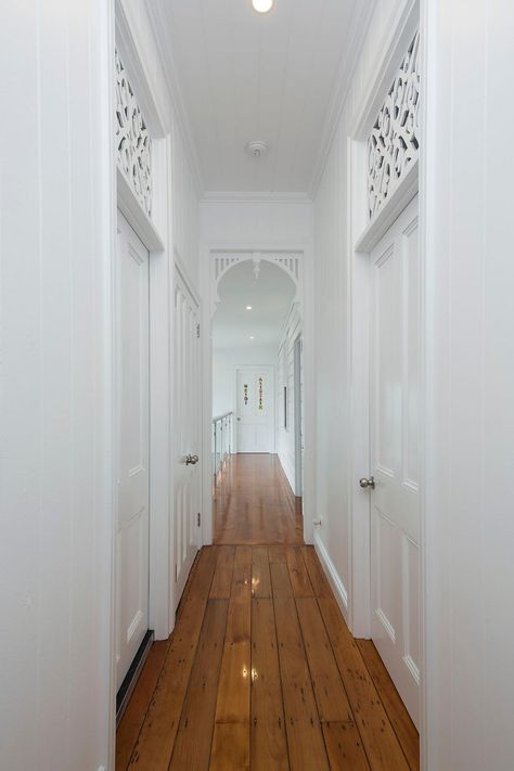 A beautifully renovated Queenslander home hallway featuring heritage breezeways and archways. #queenslanderhouse #queenslanderstyle #queenslanderhome #queenslander #queenslanderrenovation #brisbanerenovation Coastal Flooring Ideas, Queenslander Homes Interior, Queenslander Homes Exterior, Renovated Queenslander, Queenslander Architecture, Archways In Homes, Queenslander Renovation, Queenslander House, Home Hallway