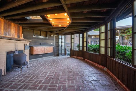 A Bernard Maybeck–Designed Home With an Expansive Deck and Sunroom Seeks $1.5M in the Bay Area - Dwell Outdoor Clubhouse, Bernard Maybeck, Brick Floor, Brick Flooring, East Bay, The Bay Area, House Room, Outdoor Fireplace, Modern Homes