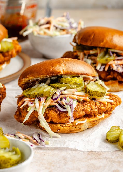 Nashville Hot Chicken Sandwiches are bursting with the most delicious spicy, slightly sweet flavor! Perfectly seasoned fried chicken with a super crunchy crust and juicy, moist center is coated in an irresistible hot sauce, served Nashville Hot Chicken Sandwich Sauce, Nashville Hot Honey Chicken Sandwich, Nashville Chicken Sandwich, Nashville Hot Chicken Sandwich, Nashville Hot Chicken Recipe, Savory Sandwiches, Hot Chicken Recipe, Nashville Chicken, Chicken Breast Sandwich