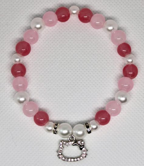 Hello Kitty Bracelet with 8mm pink glass beads, 8mm pearl beads with medium pearl spacer beads, and a silver Hello Kitty charm Kali Uchis Bracelet, Hello Kitty Bracelet Ideas, Bead Brackets, Bracelet Hello Kitty, Hello Kitty Charms, Hello Kitty Bracelet, Hello Kitty Wedding, Hello Kitty Charm, Kandi Bracelets