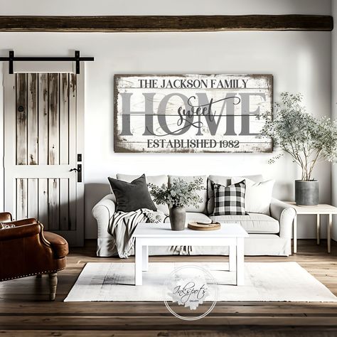 "Large Home Sweet Home sign for your  modern farmhouse living room, kitchen, bedroom or entryway featuring last name and year etablished on a distressed background. Choose from either a light, wood look background or rustic black background. The artwork also makes a beautiful and thoughtful wedding gift, anniversary gift or housewarming gift. And the beauty of canvas ...  the colors are very vibrant, it's lightweight and super easy to hang, so you won't need to hassle with finding the right lags and hardware to hang a heavy wood sign. Signs are made-to-order on genuine artist canvas that has a patented, warp-resistant construction, so there won't be any sagging. Each canvas is 1.25\" deep and comes with a sealed finish backing and pre-installed hanging hardware.  READY TO ORDER  Ordering i White And Wood Decor Living Room, Rustic Farmhouse Style Living Room, Family Picture Decorating Ideas, Farm Style Living Room Decor, Modern Farmhouse Living Room Wall Decor Behind Couch, Farmhouse Livingrooms Design, Long Living Room Wall Decor Ideas With Tv, Black Farmhouse Decor Living Room, Modern Farmhouse Apartment Decor