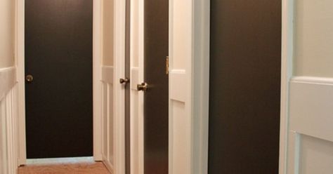 What do you think about painting interior doors dark brown/black?  I'm trying to add some architectural details to my 1979 fixer-upper house & love the way… Brown Wood Floors, Painting Interior Doors, Brown Interior Doors, Grey Interior Paint, Black Door Knobs, Best Interior Design Websites, Painted Interior Doors, Fixer Upper House, Black Interior Doors