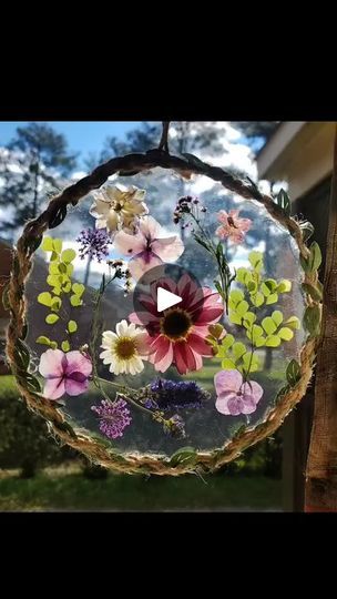 Here's my edited down Live of how to make the pressed flower suncatchers! 🌼 I used shrinky dink sheets but you can use any clear plastic you have around... | By Love Crafted Decor | Today, we're making some
suncatchers with dried pressed flowers. What we're making
these out of, what I made mine out of are these shrinky dink
sheets. You can use like other, any type of other plastic. This
is just what I already had from doing a craft with my boys. I
had to use about two of these. They are really thick so I
can't cut 'em together at the same time. I got this little
pale thing that I used to trace it just to get this size of a
circle. So, I just marked around this onto my little
clear shrinky dink paper. Start with just cutting one and then
I go back and cut the other one because the paper is Diy Shrinky Dink, Dried Pressed Flowers, Clear Plastic Sheets, Suncatcher Craft, Shrinky Dink, Dried And Pressed Flowers, Plastic Sheets, A Craft, My Boys