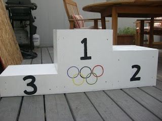 pretend olympic podium Team Olympic Games Party Ideas, Olympics Themed Parade Float, Olympic Float Ideas, Olympic Podium Diy, Olympic Parade Float Ideas, Olympic Trunk Or Treat, Diy Olympic Podium, Olympic Vbs Decorations, Olympic Decorations