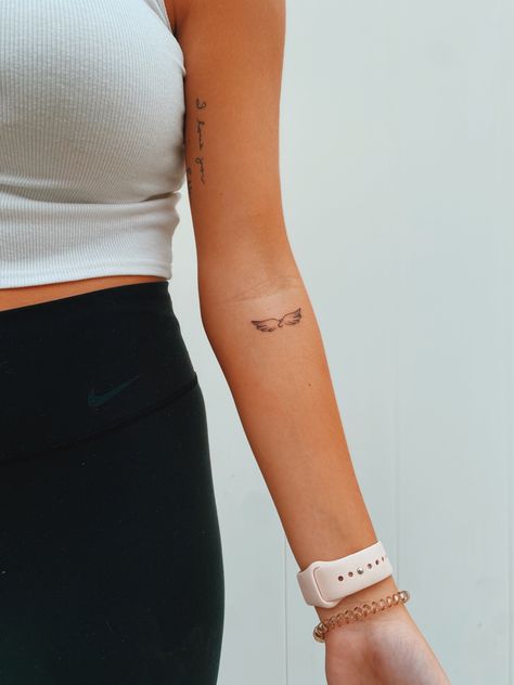 Angel Wings Tattoo Forearm Small, Angel Wings On Forearm Tattoo, Angel Wings Tattoo Inner Arm, Tiny Tattoo Forearm, Angel Wing Dainty Tattoo, Angel Tattoo Danty, Simplistic Angel Wings Tattoo, Cute Small Forearm Tattoos For Women, Cute Tattoo Words