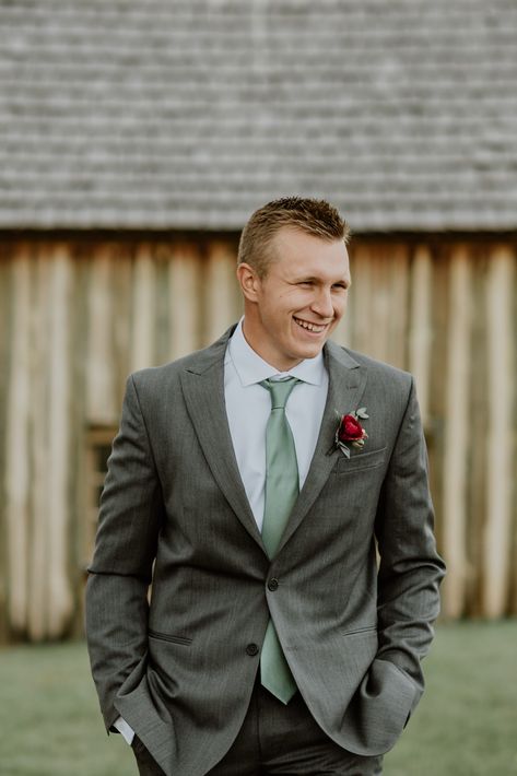 Gray Suit Sage Tie, Grey Green Tuxedo Wedding, Groomens Attire Sage Green, Grey And Sage Wedding Suit, Grey Tux With Green Tie, Charcoal Grey And Sage Green Wedding, Dark Grey And Sage Wedding, Gray Suit With Sage Green Tie, Gray Tux With Sage Green