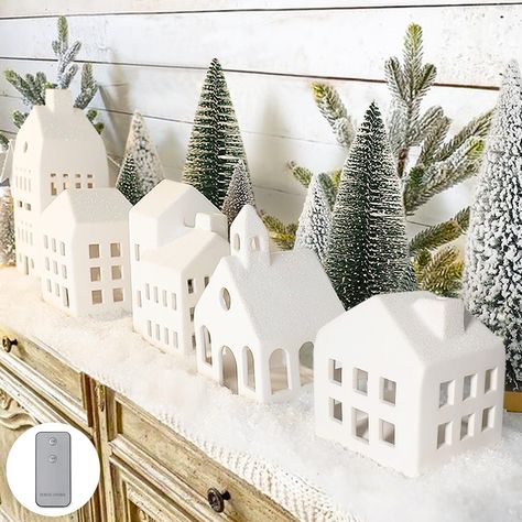 PRICES MAY VARY. Charming Miniature Christmas Village - Transform your home into a winter wonderland with our lighted white Christmas village houses and mini Xmas trees, creating a magical scene reminiscent of a snowy Christmas Eve. Package Includes - 5 Lighted white Christmas village houses, 9 mini Christmas trees and a remote control. Remote Control - Simply push the switch, and you can instantly envelop the Xmas houses in a warm and cozy glow. Size & Material - Made of ceramic. Christmas village houses measure 4 inches to 8.6 inches tall, trees measure 3.5 inches to 10 inches tall Farmhouse Decor - Display this Christmas village set on mantle, shelf, or tabletop during the Winter and Christmas seasons. It's the perfect farmhouse decor for your home. Winter Village LED Tea Light 20 Piece White Christmas Village, Miniature Christmas Village, Christmas Decorations Indoor, Christmas Village Sets, Table Room, Snowy Christmas, Christmas Village Houses, Xmas Trees, Christmas Mantle