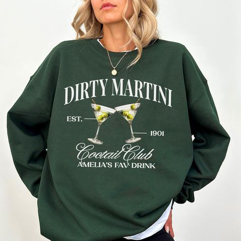 "Are you looking for the perfect dirty martini sweatshirt? This cocktail sweater makes the perfect gift for that espresso lover, cocktail club, or bachelorette club. Pick up this bachelorette sweatshirt today for yourself or as a gift! 🌻HOW TO ORDER  Step 1: Please, check and review all photos. Step 2: Choose your color and size. Step 3: If desired, add any special requests in the \"Add your personalization\" box. Step 4: Determine the quantity you wish to purchase. Step 5: Click add to cart. You can go back and follow the same steps to add more items to your cart. Step 6: Click \"Proceed to check out\"  Step 7: Add your shipping address and choose your shipping method. (PLEASE check your current address.) Step 8: You can write a note to the seller for any requests before checking out. 🌻 Inexpensive Christmas Gifts, Mrs Sweatshirt, Inexpensive Christmas, Cocktail Club, Santa Shirts, Future Mrs, San Jose Ca, Social Club, Look Plus