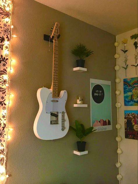 Indie wall guitar wall leaves and flower wall aesthetic cute Room Guitar Aesthetic, Guitar Wall Mount Aesthetic, Wall Mounted Guitar Ideas, Guitar Wall Display Bedroom, Guitar Hanging Ideas Bedroom, Bedroom Guitar Setup, Guitar Mounted On Wall Decor, Hanging Guitars On Wall Ideas Bedroom, Guitar Themed Bedroom