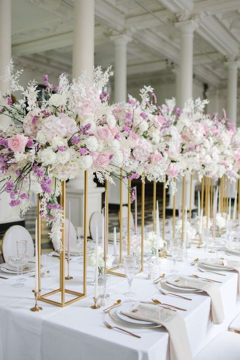 Glam wedding tablescape with sky high floral centerpieces in lavender and white tones | wedding reception, wedding reception decorations, wedding reception decor ideas, wedding tablescape, tablescape decorations, wedding table, wedding flowers, floral centerpieces, flower arrangements, floral wedding, floral decorations, event floral design, table settings,wedding table decor ideas, wedding tabelscapes, tablescape decorations, outdoor wedding reception, spring wedding,summer wedding decorations Table Floral Decorations, Pink Purple Wedding, Wedding Hall Decorations, Beautiful Wedding Reception, Dream Wedding Decorations, Wedding Floral Centerpieces, Wedding Company, Pastel Wedding, Lavender Wedding