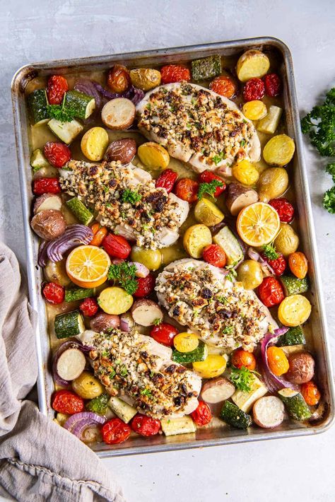 Feta stuffed boneless chicken breasts roast on a baking sheet along with colorful vegetables and halved lemons for this Greek Sheet Pan Chicken. Fresh, easy, and loaded with Greek flavor! #chickendinner #chickenrecipes #greekfood #sheetpanmeals Lemon Feta Sheet Pan Chicken And Veggies, Greek Sheet Pan Chicken Dinner, Greek Sheet Pan Chicken, Mediterranean Chicken Breast, Greek Sheet Pan, Greek Chicken Breast, Pan Chicken Breast, Roasted Vegetables With Chicken, Greek Marinated Chicken