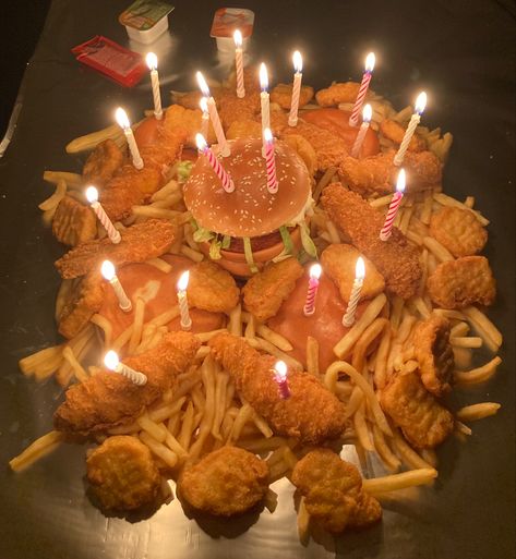 McDonald's birthday cake. 4 Cheeseburgers, 1 McChicken, 1 Tasty Chicken, 20 Nuggets, 8 Strips, 4 Large Fries. Ketchup, sweet and sour sauce and Chilli lime sauce. And 4 McFlurries for dessert! Mcdonalds Party Food Table, Mcdonalds Birthday Party Decoration, Hamburger Cake Birthdays, Mcdonalds Birthday Cake, Mcdonald’s Themed Birthday Party, Wingstop Cake, Burger Cake Birthday, Mcdonald’s Wedding, Mcdonald’s Birthday