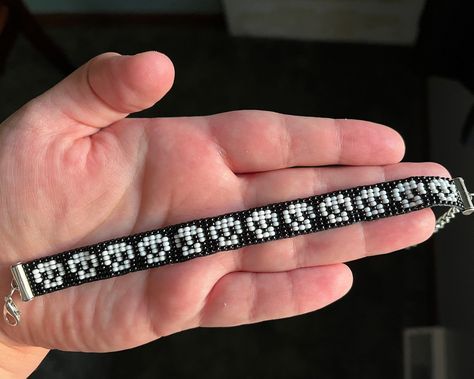 Master the Art of Bracelet Making with These Book Patterns Seed Bracelets Diy, Horror Beaded Bracelet, Small Bead Loom Patterns, Beaded Skull Bracelet, Skull Beaded Bracelet, Pixel Art Bracelet Pattern, Skull Bead Bracelet, Gothic Beaded Bracelet, Pixel Art Bracelet