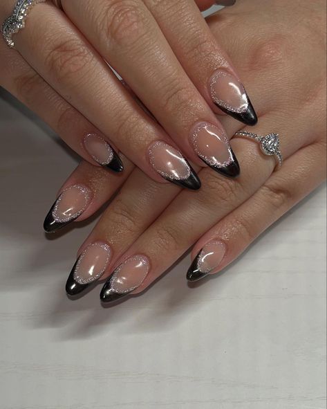 Black French tip nails with a touch of reflective glitter #frenchtipnails #reflectiveglitter #nailinspiration #newyearsnails Mail Ideas For Black Dress, Black Nails With Glitter Almond Shape, Black And Silver Nails Almond Shape, Nails With Black Sequin Dress, Black French Tip With Sparkle Line, Black Shimmer French Tip Nails, Black Metallic French Tip Nails, Nails Matching Black Dress, Prom Nails Black Almond