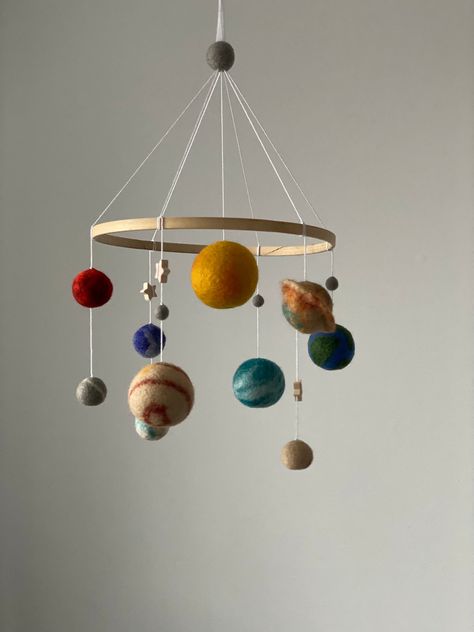 Solar system mobile  are ideal as a décor for a children's room. Baby mobile add that perfect final touch to your new little one's nursery. Gorgeous, delicate and light crib mobile will for sure be the focal centerpiece of your nursery or any other room in your house . This  felted mobile is perfect decoration for a baby girl nursery room. It will surely become a wonderful design item in your kid's room. Baby mobile is first wonderful present for your baby or if you want  make the ideal baby sho Crib With Mobile, Diy Space Nursery Decor, Girl Space Nursery, Planets Mobile, Felted Mobile, Homemade Mobile, Crib Mobile Girl, Planet Mobile, Solar System Mobile