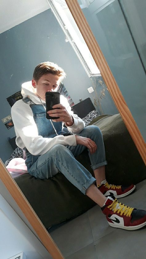 A guy in blue jeans overalls with a white hoodie, sitting on a bed and wearing some nice nike jordan Dungarees Outfits, Guys Photos, Overalls Outfits, Boys Overalls, Clothes Reference, Overalls Men, Cute White Guys, Human Male, Bib Overalls