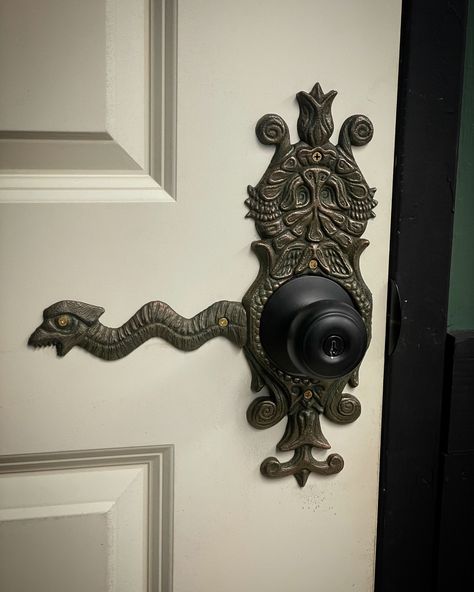 "Decorative doorknob backing plate that is sure to add the flair of a victorian haunted mansion to any door. This item comes in black, white, or silver or bronze, surfaced with real metal. Each purchase includes two removable \"snakes\" and hardware for installation on a left or right-hand swinging door. Fits up to a 3 inch doorknob radius." Black Victorian Interior, Unique Door Knob, Door Finger Plates, Victorian Era Decor, Victorian Gothic Decor Bedroom, Interior Door Decor, Over The Door Decor, Witchy Home Aesthetic, Dust Corners