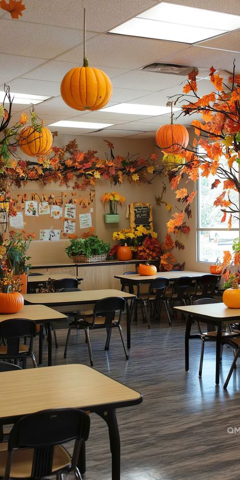 Whimsical classroom decor for fall with pumpkins hanging from the ceiling, orange foliage, and cute autumn crafts adorning the walls and tables. Seasons Classroom Decorations, Fall Classroom Boards, Fall Decor For School, November Classroom Themes, Fall Party Classroom Ideas, Classroom Thanksgiving Decorations, Thanksgiving Classroom Decor, Thanksgiving Decorations For Classroom, Fall Decorations Classroom