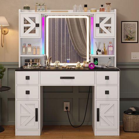 PRICES MAY VARY. 【Makeup Vanity with LED Lighted Mirror & RGB Light Bars】The vanity features a large LED mirror with 3 light settings. Use the touchscreen button to change light modes and adjust brightness, so you can always find perfect light for your makeup. The RGB ambient light bars boast of hundreds of light colors and dynamic modes, which elevate the ambience in a second. 【Built-in Power Outlet & Digital Clock in 12-Hour Mode】This modern vanity table features a power outlet including 2 USB Farmhouse Makeup Vanity, U Shaped Gaming Desk, Gaming Desk With Drawers, Gaming Desk With Storage, Barn Door Cabinet, Tv Stand Bookshelf, Modern Vanity Table, Makeup Vanity Desk, Led Beds