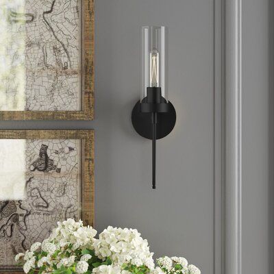 This wall sconce adds a curated look to your bedroom or entryway with its bold lines and tube-shaped bulb. Made from stainless steel, this hard-wired light features a round backplate with a drum-shaped glass shade and can be mounted with the light facing up or down. It uses one T10 100W bulb and is dimmable, letting you get the light just right. Plus, it's rated for use in damp areas, so it's great for framing your bathroom mirror or shower. Finish: Matte Black | Greyleigh™ Willingham 1 - Light Bathroom Lighting Side Of Mirror, Sconces Next To Tv Living Room, Sconses Hallway Modern, Battery Operated Sconces Wall Mount, Wall Sconces Entryway, Battery Sconces Wall Mount, Mirror With Sconces On Each Side, Fireplace Sconces Lighting, Entryway Sconces