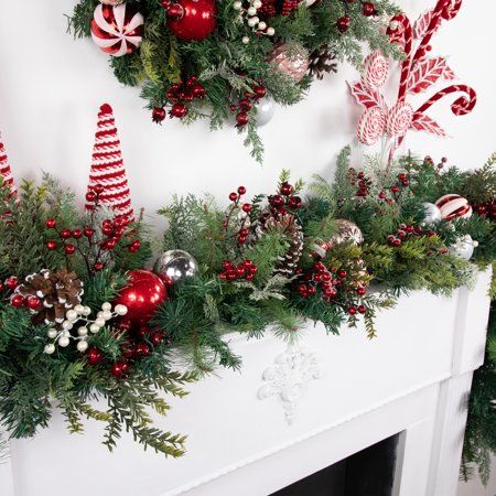 Bring the magic of the holiday season into your home with our artificial Christmas garland. Adorned with pinecones, festive ornaments, and vibrant berries, this garland sparkles with glitter accents. Perfect for draping over mantels, banisters, or doorways, its lush, realistic greenery and thoughtful decorations create a warm and inviting holiday atmosphere. Celebrate the season with this beautifully crafted garland, designed to make your home feel festive and cozy. Product Features: Unlit. Deco Holly Christmas Decorations, Modern Fireplace Christmas Decor, Christmas Mantel With Tv, How To Hang Garland Around Doorway, Christmas Shelves Decor, Christmas Berry Decor, Fireplace Christmas Decor Ideas, Indoor Christmas Garland, Farmhouse Christmas Garland