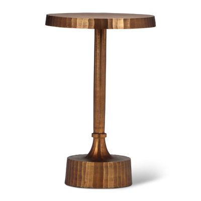 This end table is an artistically rendered piece that shows off a bold modern look for any room. It's crafted from reclaimed aluminum with a round pedestal base, a gracefully elongated neck, and a circular top. What sets it apart is the intricate faceted design, a detail that infuses depth and personality into every piece. Through an artisanal hand-casting process, each table acquires a distinct antique brass patina, echoing a tale of resilience and individuality. | Wade Logan® Chanze End Table Hand Casting, Tall End Tables, Faceted Design, Brass Patina, C Table, End Table Sets, Wood End Tables, Aluminum Table, Drink Table