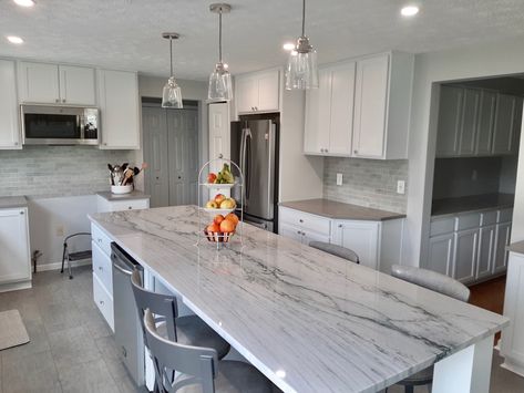 White and gray are timeless colors for a kitchen design! This kitchen island counter is a natural stone called quartzite. Strong, beautiful stone similar to marble. The perimeter countertops are a gray engineered quartz. Quartzite Island, Kitchen Island Counter, Kitchen Staging, Stone Counter, Island Counter, White Island, Newbury Park, Engineered Quartz, Stone Counters