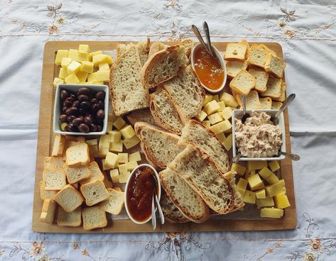 Charcuterie board made of 2 different types of cheeses, mini toast, slices of bread, orange jam, pumpkin jam, olives and tuna patê. Bread And Jam Charcuterie Board, Charcuterie Board With Bread, Jam Charcuterie Board, Bread And Cheese Board, Bread Charcuterie Board, Mini Toast, Sunday Tea, Oak Knoll, Quarter Quell