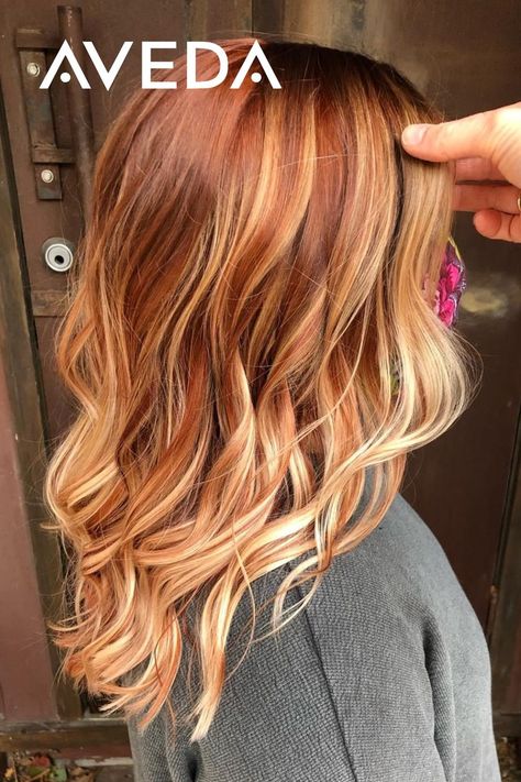 Adding a copper twist to your summer balayage is a great way to transition your hair for the fall season. These warm red and copper tones are reminiscent of our favorite colors of autumn. Click to find an Aveda Salon near you to achieve your own autumn hairstyle. Aveda Artist @shauna_planethair #CopperBalayage #FallHairColor #RedHair #WavyHair #CopperHair #MediumLengthHairstyles Dark Auburn Hair With Blonde Balayage, Red Bayalage Hair With Money Piece, Cooper Red With Blonde Highlights, Half And Half Hair Color Underneath Red, Red Hair With Blonde Balayage Ombre, Red Hair With Blonde Highlights Money Piece, Blonde Hair With Copper Highlights Low Lights, Root Smudge Strawberry Blonde, Blond Copper Highlights