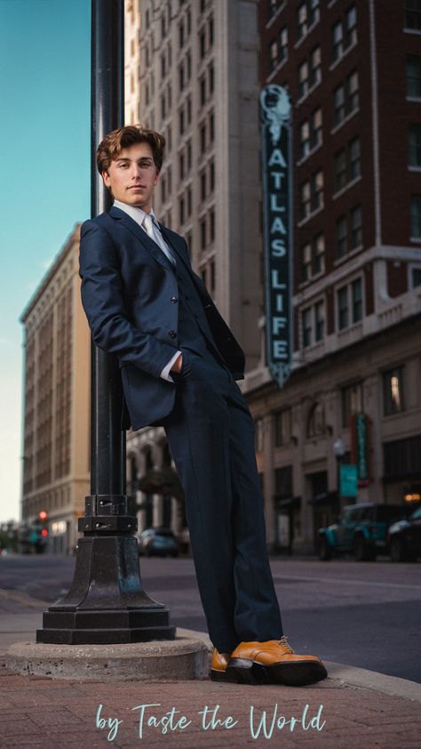 A senior boy in downtown Tulsa. He's wearing a cool blue suit and leaning on a light post with his hands in his pockets. He looks relaxed and cool. Male Clothing Model Poses, Prom Photos Guys, Dressy Senior Pictures, Posing Men Photography, Guy Leaning On Wall, Men Poses Photography Ideas Photo Shoot, Senior Portraits Boys Posing Ideas, Suit Senior Pictures, Senior Boy Downtown Pictures