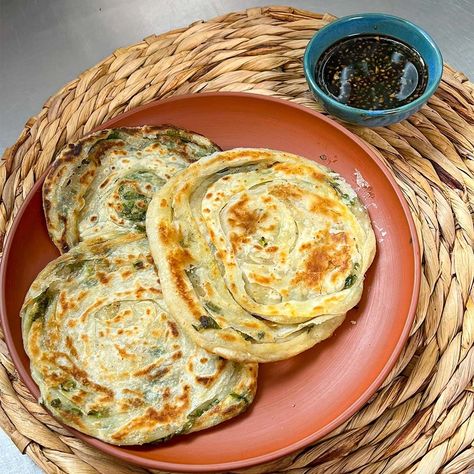 Also known as a scallion pancake, Cong you Bing is a savory Chinese dish that's pan-fried to perfection! Slightly chewy and studded with green onions, they're often eaten as street food. Chinese Scallion Pancakes Recipe, Chinese Pancakes, Scallion Pancakes Chinese, Scallion Pancake Recipe, Chinese Pancake, Green Onion Pancake, Onion Pancake, Scallion Pancakes, Mouth Watering Food