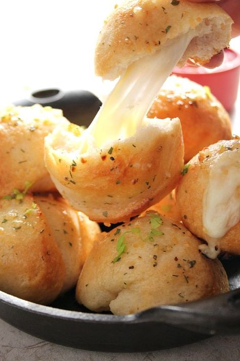 Easy Garlic Cheese Bombs Recipe - biscuit bombs filled with gooey mozzarella, brushed with garlic Ranch butter and baked into perfection. Easy, fast and absolutely addicting!