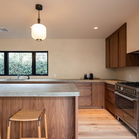 Utilizing modern elements and techniques while keeping with the design theme is an art in itself. This is a mid century home where we included elements in the kitchen which are found in mid century furniture design such as integrated walnut finger pulls on the cabinetry and concrete countertops with exposed aggregate which is often found in mid century concrete work. #homeremodeling #remodeling #homeremodel #kitchenremodel #residentialconstruction #homerenovation #customhome #buildersofinsta... Walnut Mid Century Kitchen, Concrete Work, Modern Kitchen Renovation, Exposed Aggregate, Concrete Countertops Kitchen, Mid Century Home, Century Home, Concrete Kitchen, Mid Century Modern Kitchen