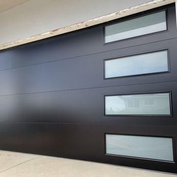 Steel Sectional Garage Doors – Lux Garage Doors Garage Doors 2022, Garage Door With Windows Modern, Garage Doors With Glass Panels, Dark Garage Doors Grey House, Modern Steel Garage Door, Black Garage Doors With Windows, Modern Garage Door Styles, Black Garage Door With Windows, Modern Garage Doors With Windows