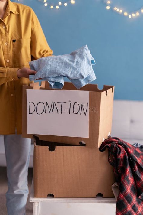 Donation Concept. Woman putting clothes in Donate Box at home stock photography Clothing Donation Poster, Clothes Donation Poster, Donate Clothes Poster, Donation Picture, Best Charities To Donate To, Box Houses, Stock Photography, Photo Image, Stock Photos