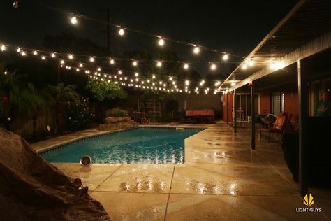 Take your backyard to the next level with Italian string lighting. Backyard Lighting With Pool, String Lights Over Pool, Pool 2023, Backyard Lights, Backyard String Lights, Backyard Pool Design, Pool Lighting, Garden Playhouse, Outdoor String Lights Patio