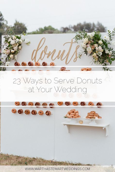 23 Ways to Serve Donuts at Your Wedding That Your Guests Will Love! These fun reception desserts are a creative alternative to classic wedding cake. #WeddingIdeas #WeddingFood #WddingDonuts #FunWeddingFood | Martha Stewart Weddings - 23 Delicious Ways to Serve Donuts at Your Wedding Donut Wall For Wedding Reception, Donuts Wall Wedding, Doughnut Dessert Table Wedding, Donut Reception Ideas, Donuts Instead Of Wedding Cake, Donuts Serving Ideas, Doughnut Table Ideas, Wedding Donut Bar Dessert Tables, Doughnut Wedding Cakes