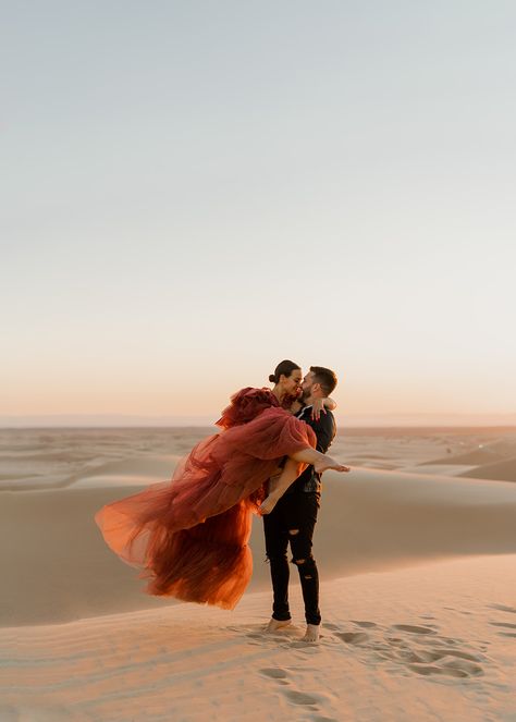 Engagement session of couple in the sand dunes Sand Dunes Proposal, Glamis Engagement Photos, Sand Dune Wedding Pictures, Egypt Engagement Photos, Glamis Sand Dunes Photoshoot, Engagement Photoshoot Themes, Sand Dune Couple Photoshoot, Sand Dune Engagement Photos, Desert Wedding Photoshoot