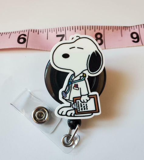 Want to see more awesome badge reels?  Please visit my eBay store:  https://www.ebay.com/str/GoldenGooseIDBadges?_trksid=p2047675.l2563 -  Sturdy retractable badge holder -  Perfect for staff and professionals working at school, office, hospital, and factory. -  Swivel Alligator clip badge reel with metal clip on the back. Up to 24 inches retractable cord - let you scan badges easily from a distance. -  This is a great gifts for nursing students, nurses, teachers, colleagues and anyone who are r Nurses Christmas Gifts, Nursing Student Badge Reel, Cna Badge Reel, Snoopy Doctor, Healthcare Accessories, Nursing Students Aesthetic, Gifts For Nursing Students, Gifts For Doctor, Nurse Badges