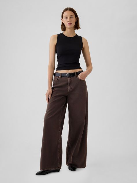 Fit: A supersoft, full-length baggy jean that's fitted on the waist & relaxed all the way down.  ​ Fabric: 60% Cotton, 40% TENCEL™.  Stretch:   No Stretch Jeans.  Authentic denim that gets better with every wear.  Made to wear all day & break in over time.  ​ Rise :  Mid Rise Jeans.  Look:  A classic five-pocket jean in a brown wash.  Details:   Zip fly & five-pocket styling.  Responsibly Made:  This pair of jeans is part of our water-saving Washwell program.  Compared with conventional wash methods, Washwell uses at least 20% less water and has saved over a billion liters of water since 2016.  Our Mid Rise Jean has a 10" 25 cm) rise. ​ Fitted at the waist and hip.  Loose, baggy through the leg.  Full-length jean.  Hits below the ankle. ​ 26" 66 cm) leg opening.   ​ Inseam: Petite 28. 5" 7 Brown Baggie Jeans, Brown Jeans Outfit Winter, Styling Brown Jeans, Brown Jean Outfit, Slightly Baggy Jeans, Mid Rise Baggy Jeans, Gay Style Women, Baggy Cuffed Jeans, Baggy Jeans Outfit Winter